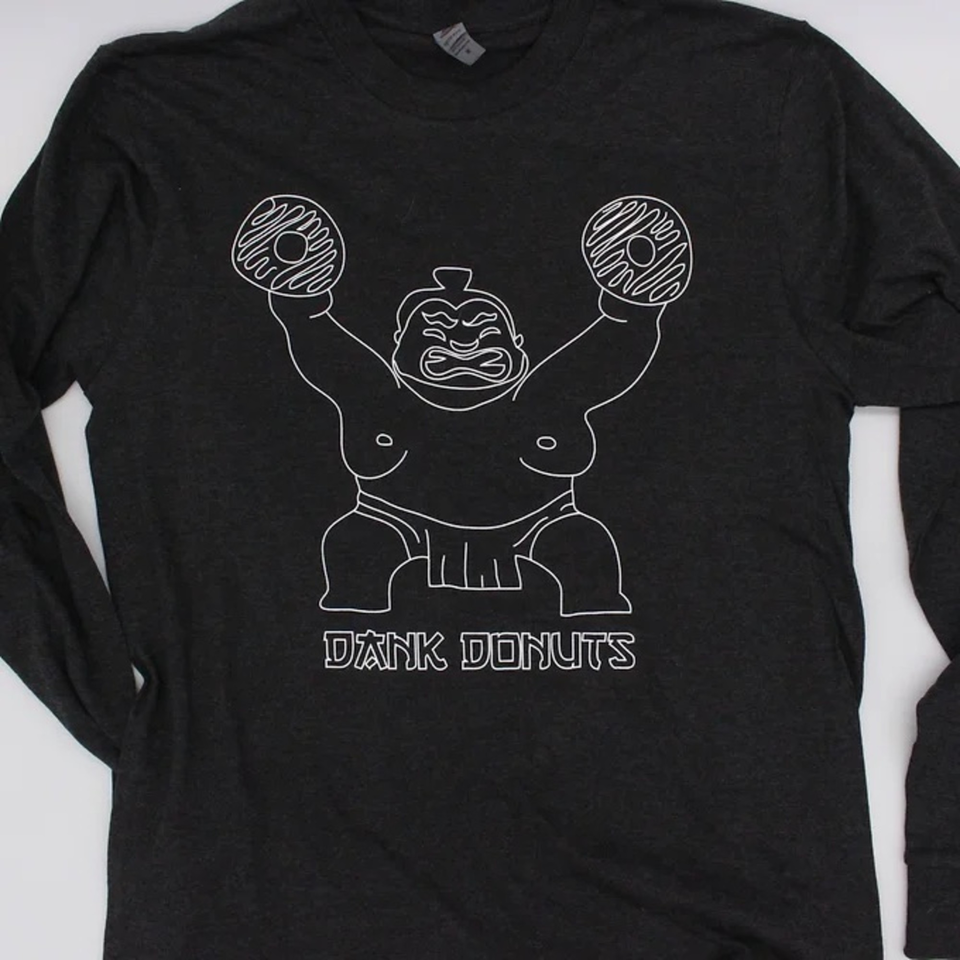 Black long-sleeved shirt with a white outline of a sumo wrestler holding two donuts.