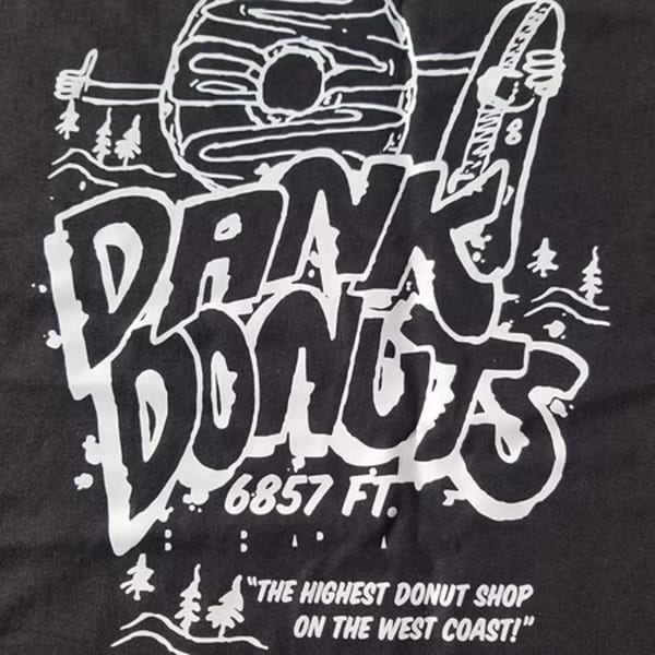 Dank Donuts logo with a donut holding a surfboard, text "6857 FT." and "THE HIGHEST DONUT SHOP ON THE WEST COAST!"