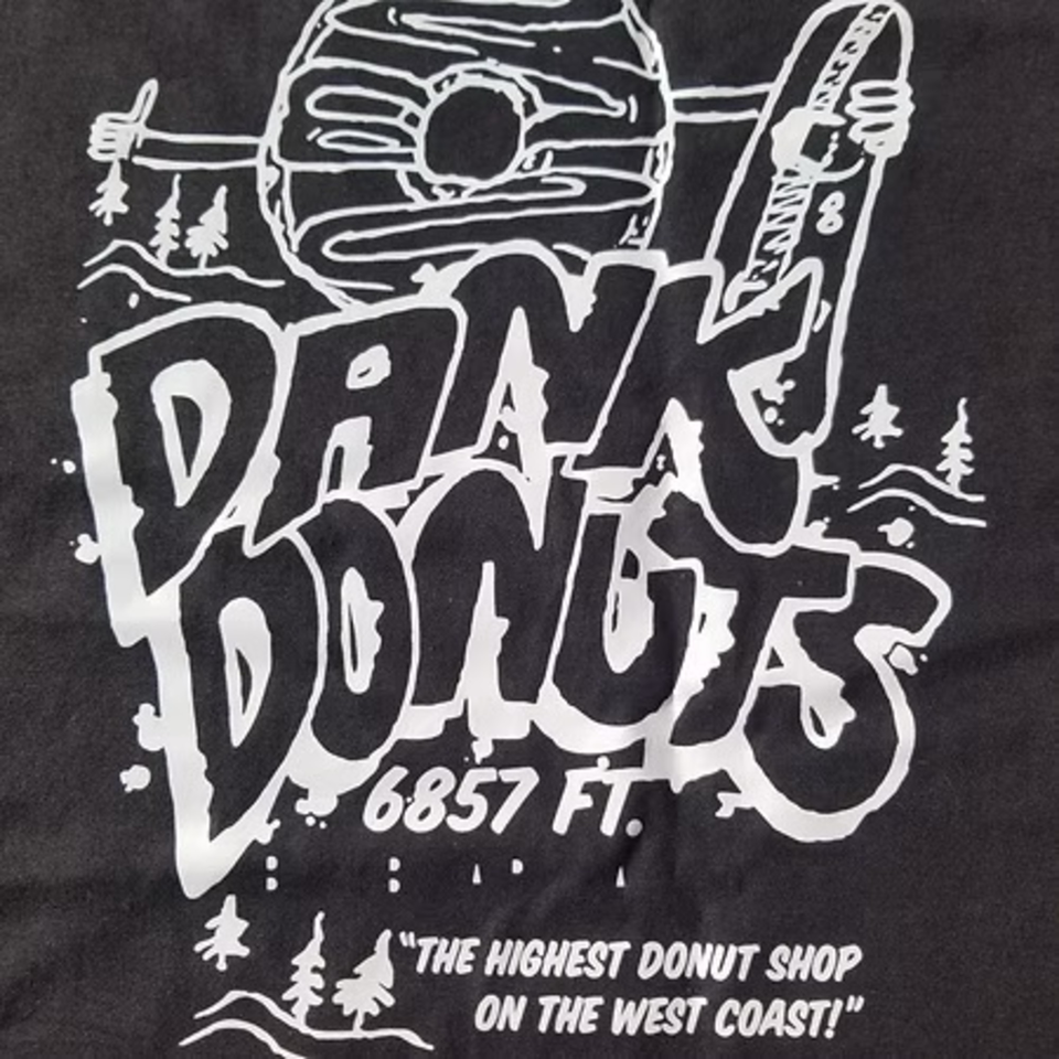 Dank Donuts logo with a donut holding a surfboard, text "6857 FT." and "THE HIGHEST DONUT SHOP ON THE WEST COAST!"