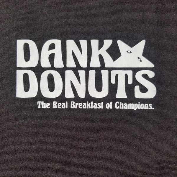 Dank Donuts logo in white on a black background, with "The Real Breakfast of Champions" tagline.