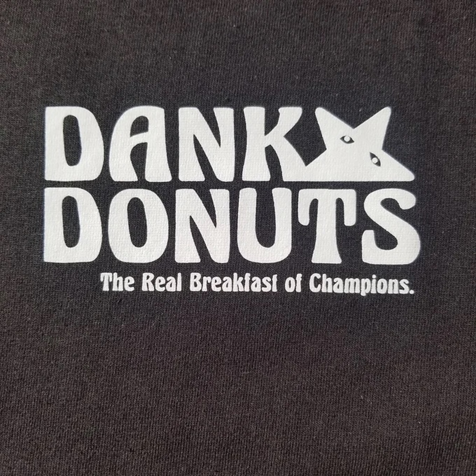 Dank Donuts logo in white on a black background, with "The Real Breakfast of Champions" tagline.