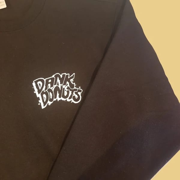 Black long-sleeved shirt with the white "Dank Donuts" logo on the left chest.